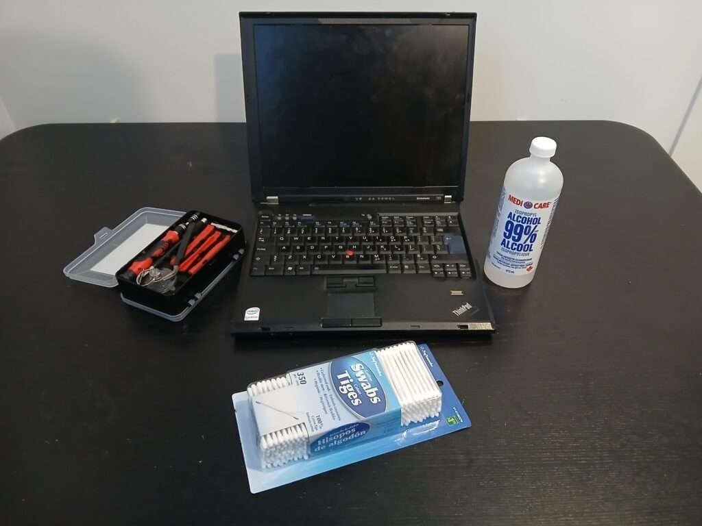 thinkpad t61 Laptop with isopropyl alcohol and a screwdriver toolkit.